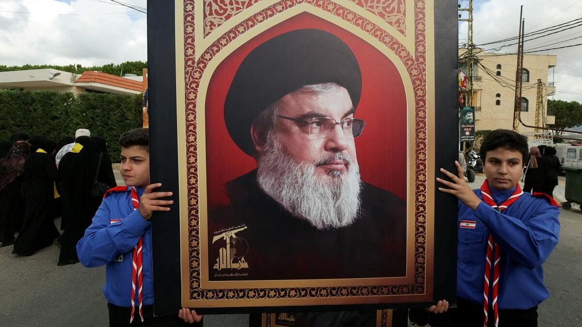 <div class="paragraphs"><p>Boys scouts carry a picture of Hezbollah leader Sayyed Hassan Nasrallah in Kfar Melki.</p></div>