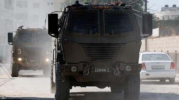 <div class="paragraphs"><p>Israeli military vehicles maneuver during an Israeli raid in Jenin, in the Israeli-occupied West Bank.</p></div>