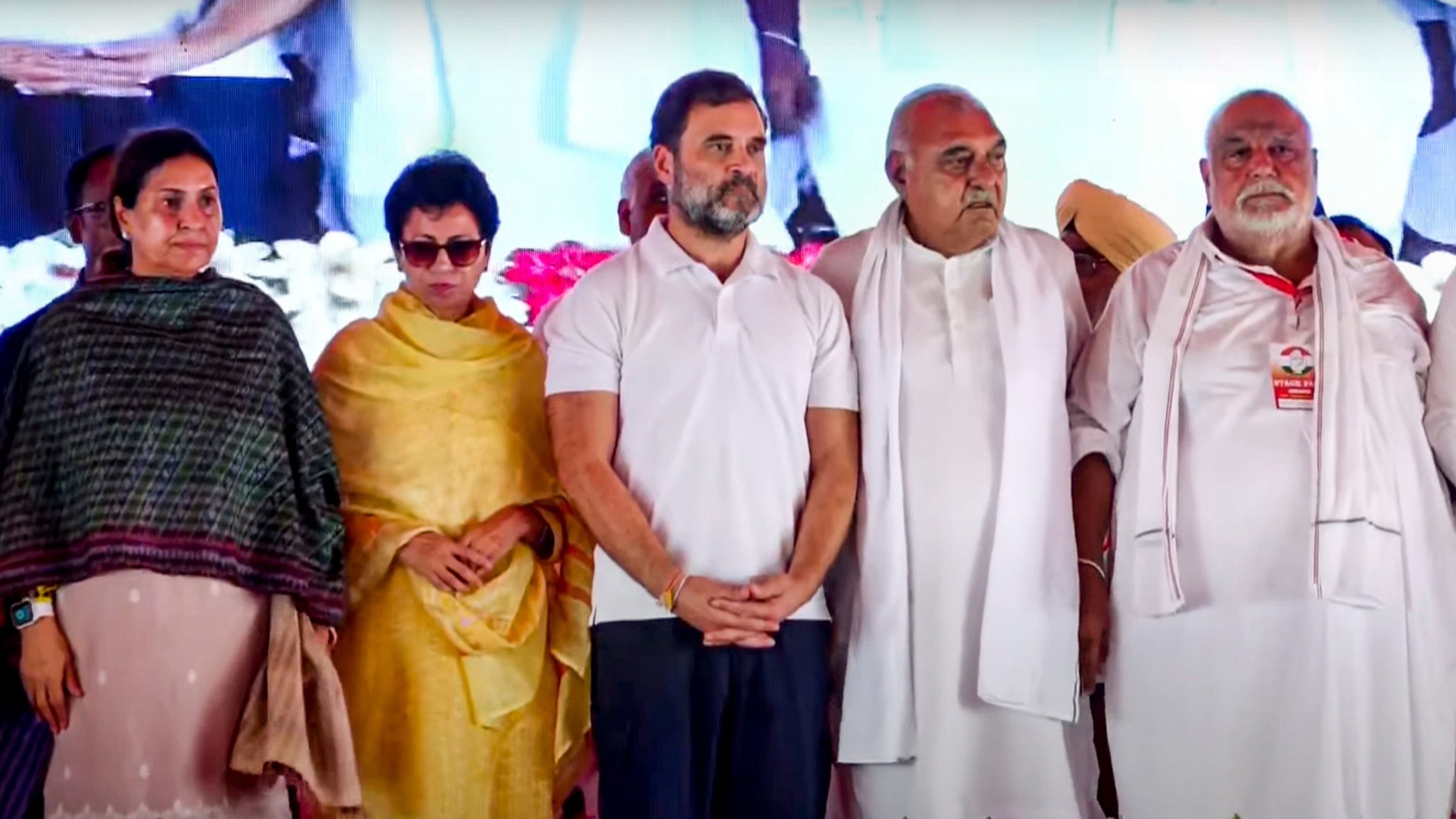 <div class="paragraphs"><p>Leader of Oppostion in Lok Sabha and Congress leader Rahul Gandhi with party leaders Bhupinder Singh Hooda and Kumari Selja during a public meeting for Haryana Assembly elections, at Assandh, in Karnal district, Haryana.</p></div>