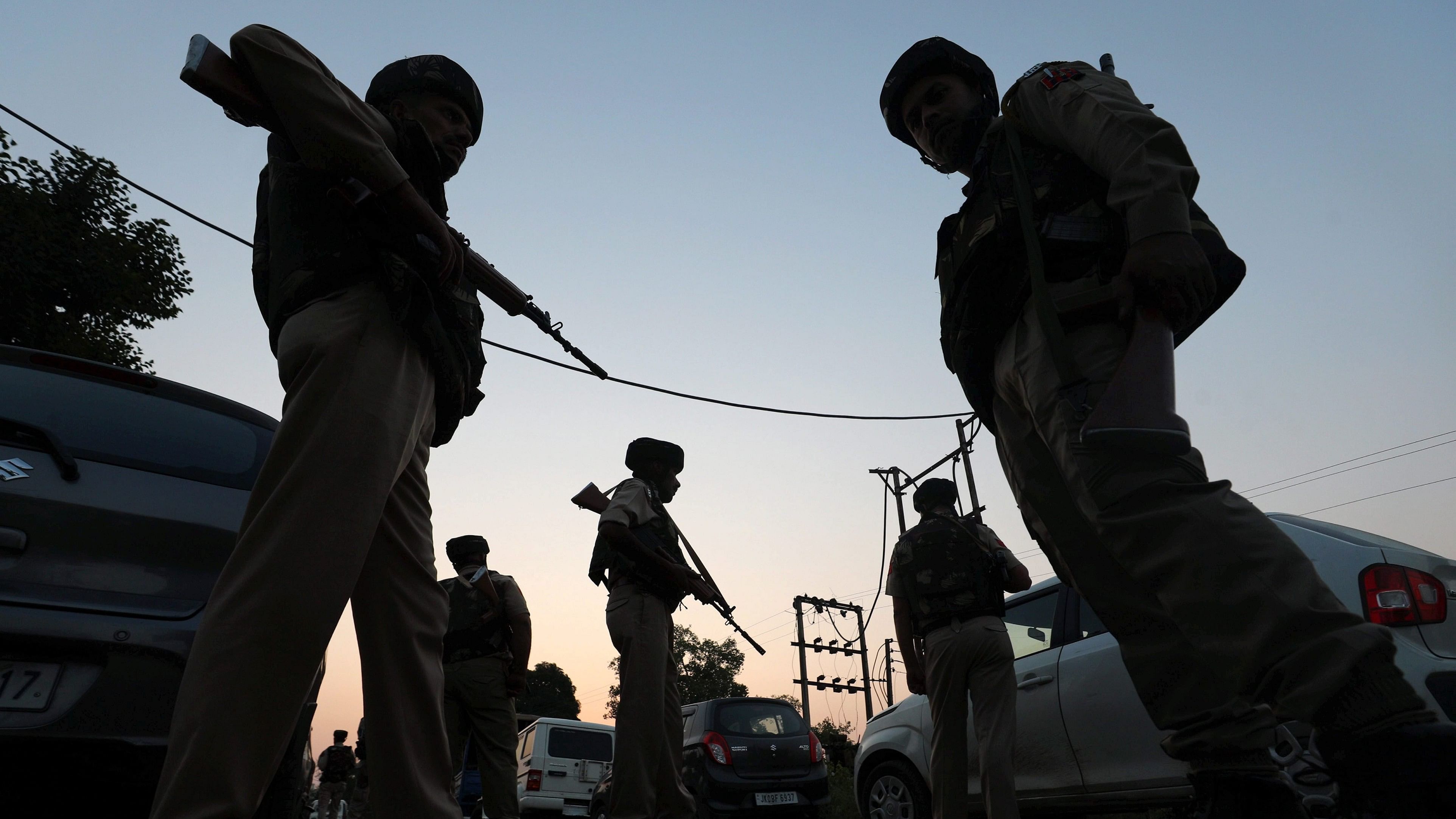 <div class="paragraphs"><p> Jammu &amp; Kashmir Police personnel stand near the site of the ongoing encounter between security forces personnel and terrorists.</p></div>