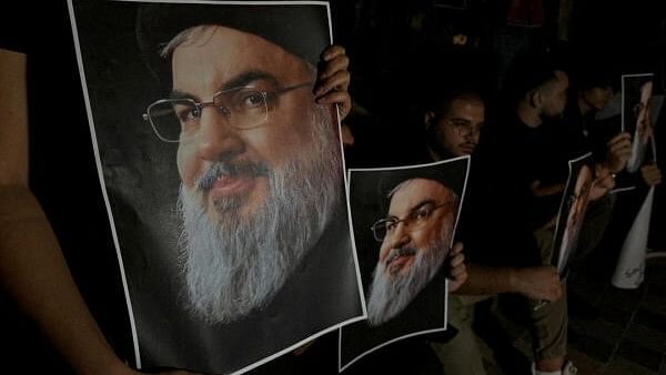 <div class="paragraphs"><p>Supporters of Lebanon's Hezbollah leader Sayyed Hassan Nasrallah carry his pictures as they gather in Sidon.&nbsp;</p></div>