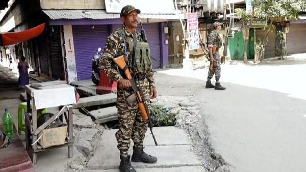 <div class="paragraphs"><p>Security personnel stand guard after a fresh violence, in Imphal, Sunday, Sept. 8, 2024.</p></div>