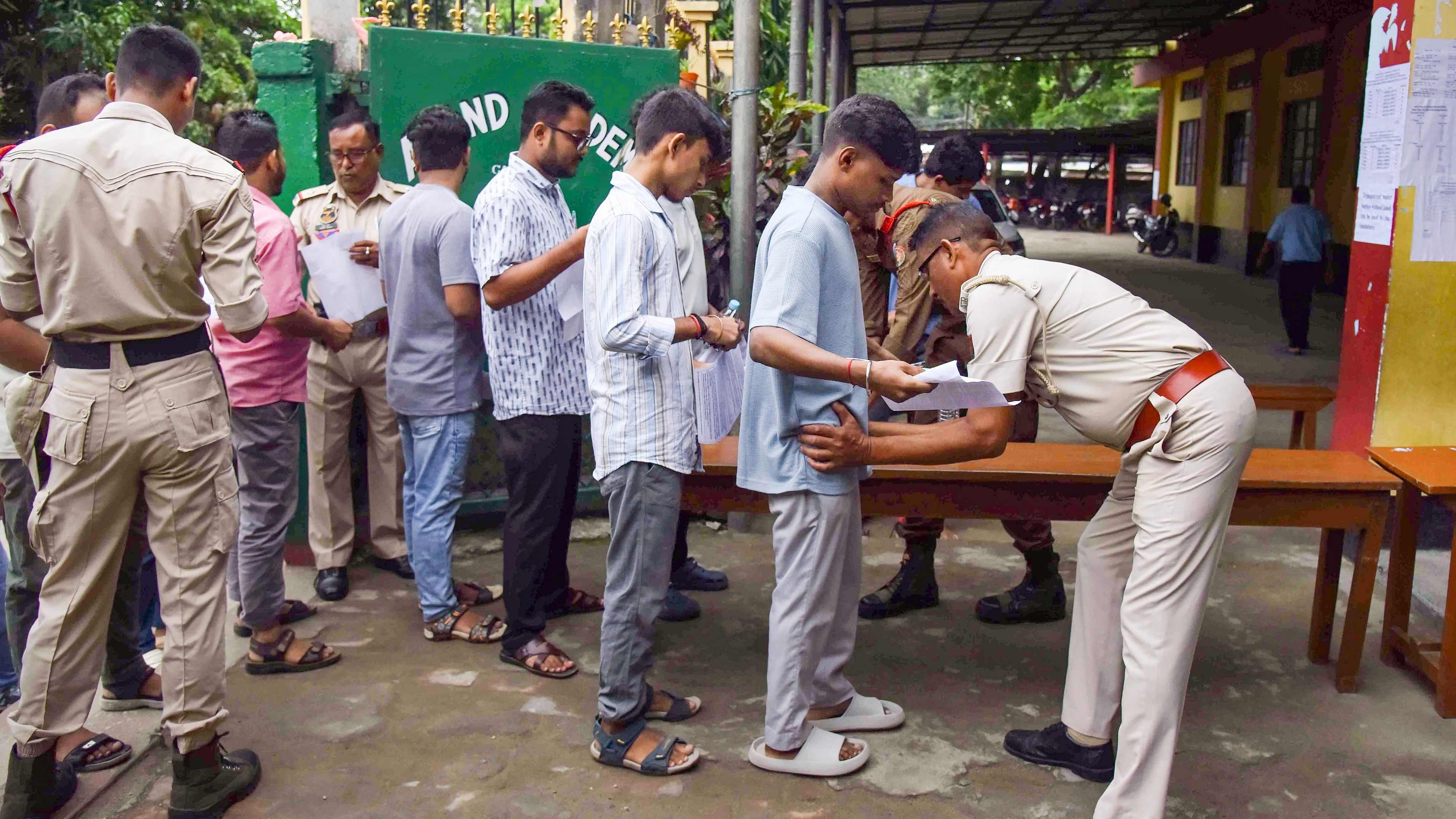 <div class="paragraphs"><p>Candidates undergo security check as they arrive to appear for the Assam Direct Recruitment Examination (ADRE) Grade 3 exam, at an examination centre, in Guwahati, Sunday, Sept. 29, 2024.</p></div>