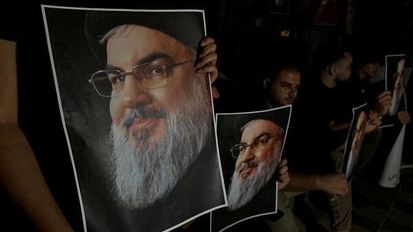 <div class="paragraphs"><p>Supporters of&nbsp; Sayyed Hassan Nasrallah carry his pictures.</p></div>