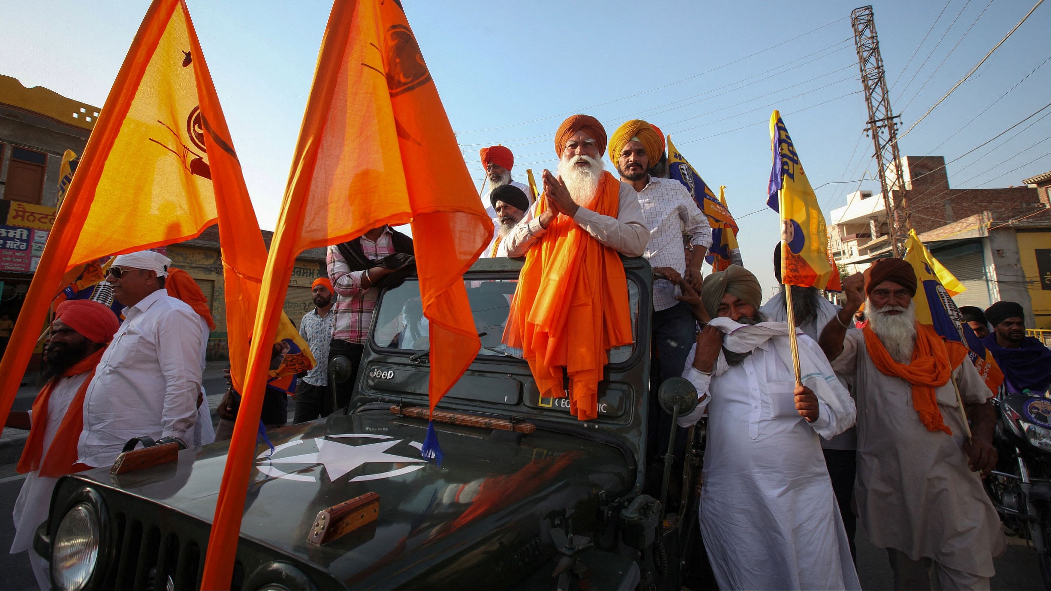 <div class="paragraphs"><p>Tarsem Singh, 61, father of Sikh separatist leader Amritpal Singh,&nbsp; stands on a vehicle during an election campaign for his son, in Bhikhiwind town in Tarn Taran district, Punjab,</p></div>