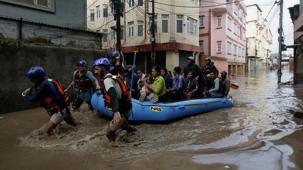 <div class="paragraphs"><p>Security force members use an inflatable raft to bring residents to safety from a flooded area near the bank of the overflowing Bagmati River following heavy rains, in Kathmandu, Nepal.&nbsp;</p></div>