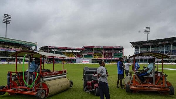 <div class="paragraphs"><p>Groundsmen at the Green Park Stadium during the third day of the 2nd Test cricket match between India and Bangladesh, in Kanpur, Sunday.</p></div>