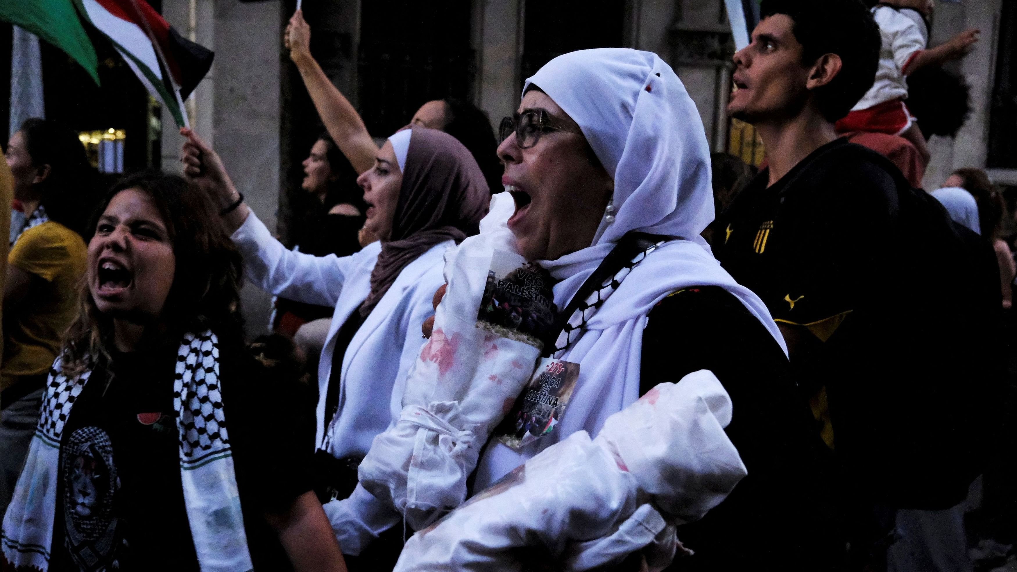 <div class="paragraphs"><p>Fatima, 47, holds symbolic shrouded mockup dead bodies of Gaza's children during a demonstration to protest the escalation of conflict between Israel and Hezbollah and to call for an end to military operations in the Gaza Strip and the Israeli-occupied West Bank, in Barcelona, Spain, September 27, 2024. </p></div>