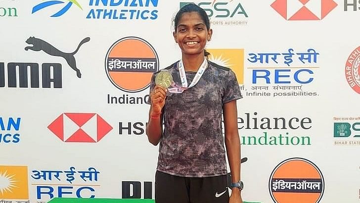 Deekshita poses with her gold medal after winning the women’s 800m hurdles event at the at the 4th Indian Open U-23 Athletics Competition in Patna on Monday.