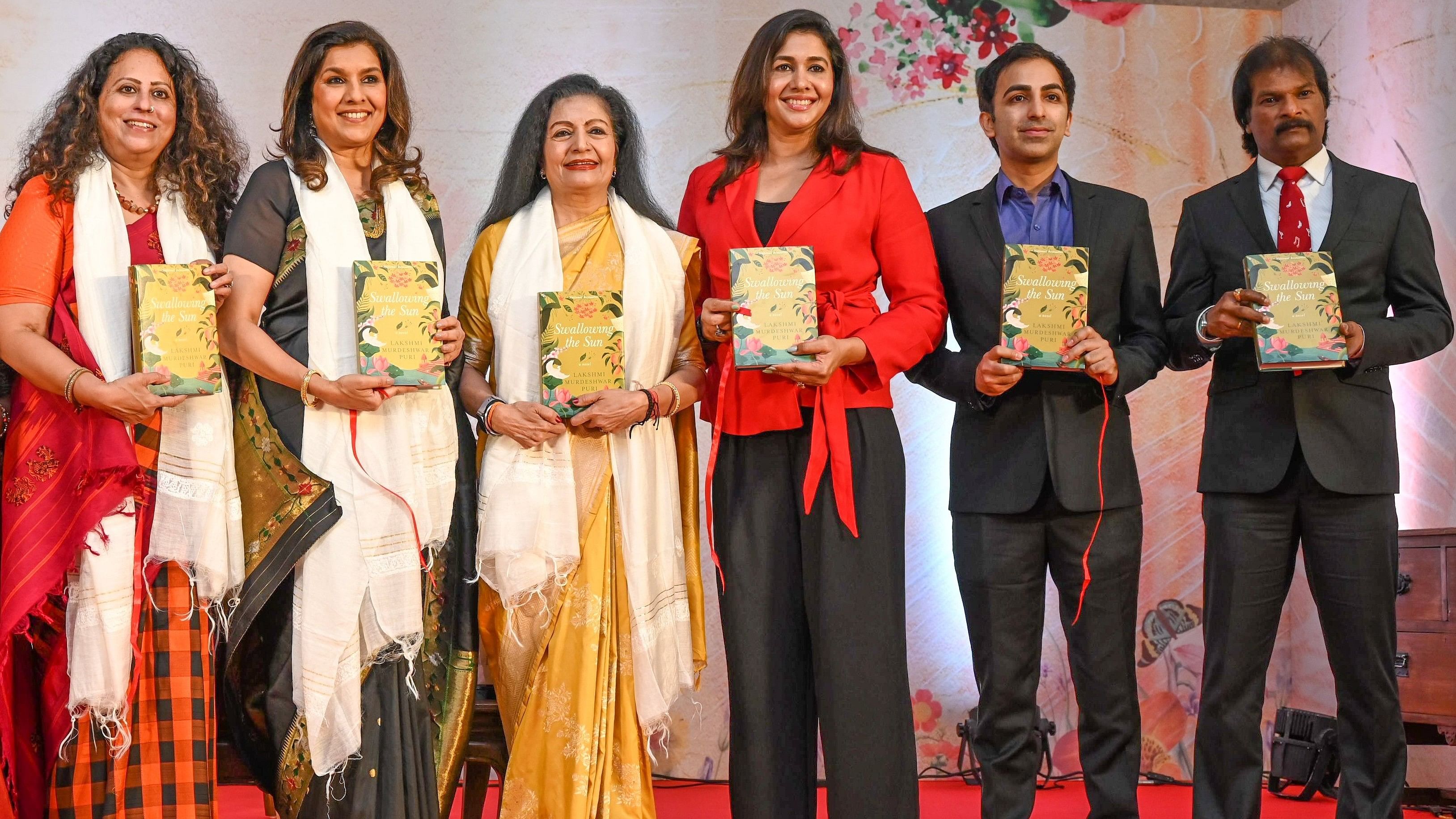 <div class="paragraphs"><p>Lakshmi Murdeshwar Puri (in yellow saree), former assistant secretary-general of the United Nations, unveiled her debut novel ‘Swallowing the Sun’ in the city on Sunday. </p></div>