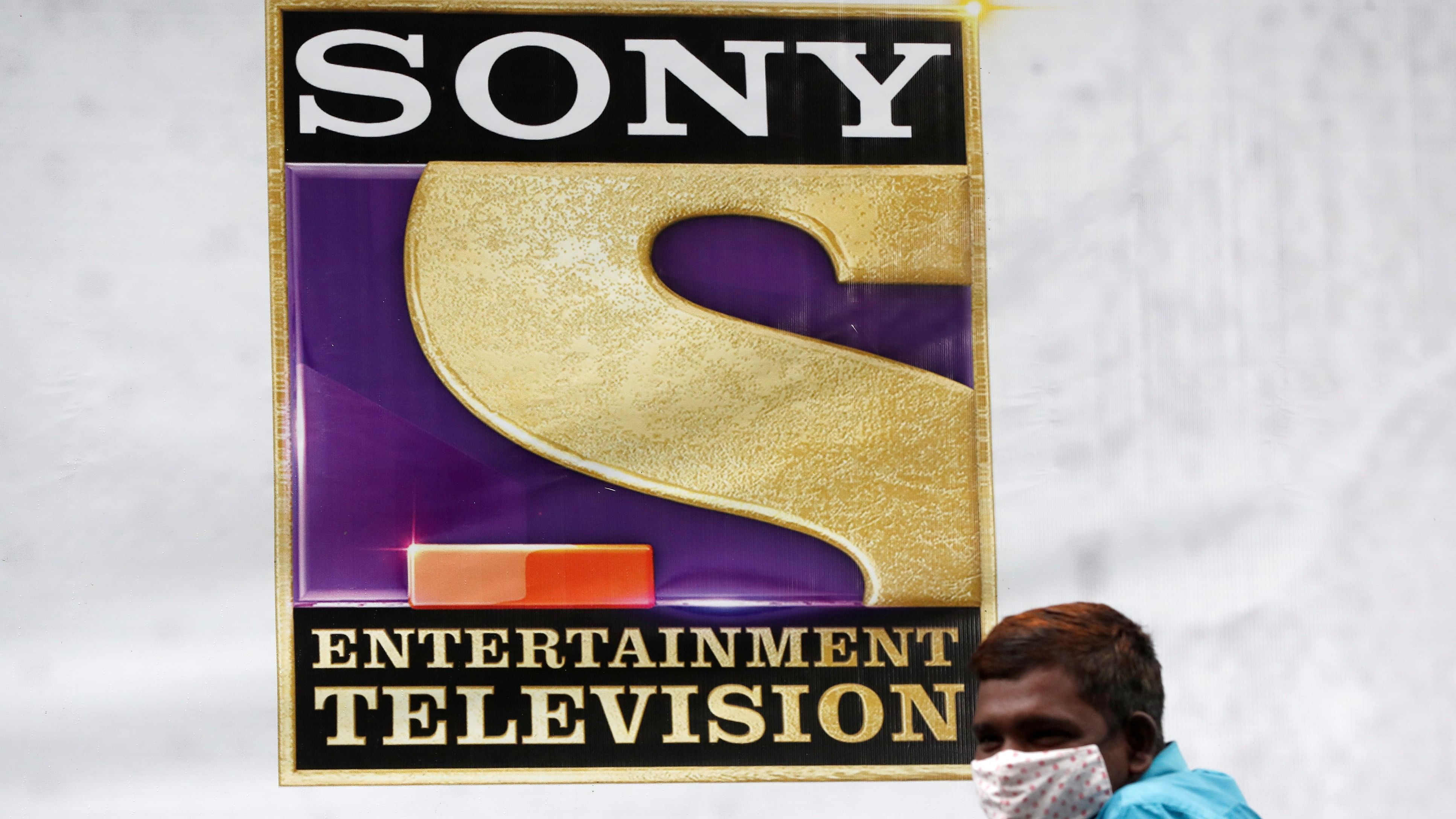 <div class="paragraphs"><p>A man stands next to a banner of Sony Entertainment, outside a film set in Mumbai</p></div>