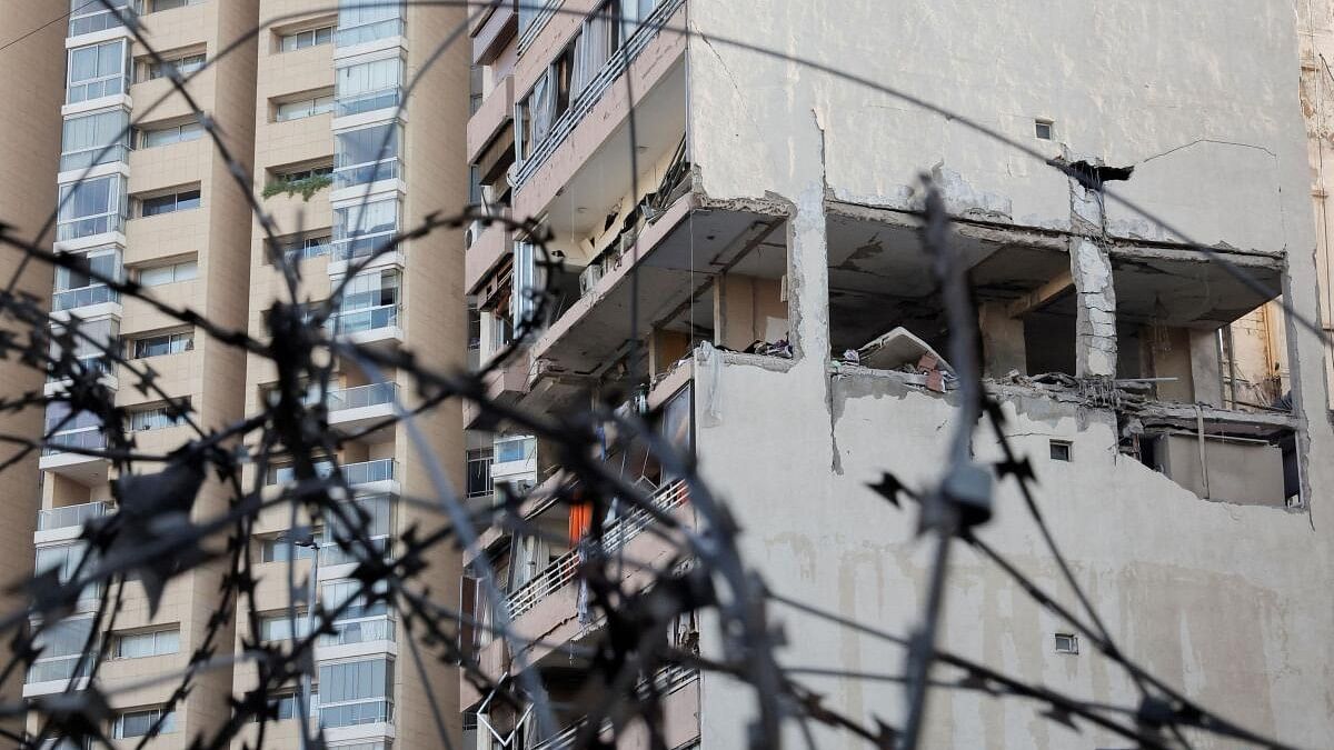 <div class="paragraphs"><p>A building damaged in an Israeli strike is seen through a razor wire fence, amid ongoing cross-border hostilities between Hezbollah and Israeli forces, in Kola, central Beirut, Lebanon September 30, 2024.</p></div>