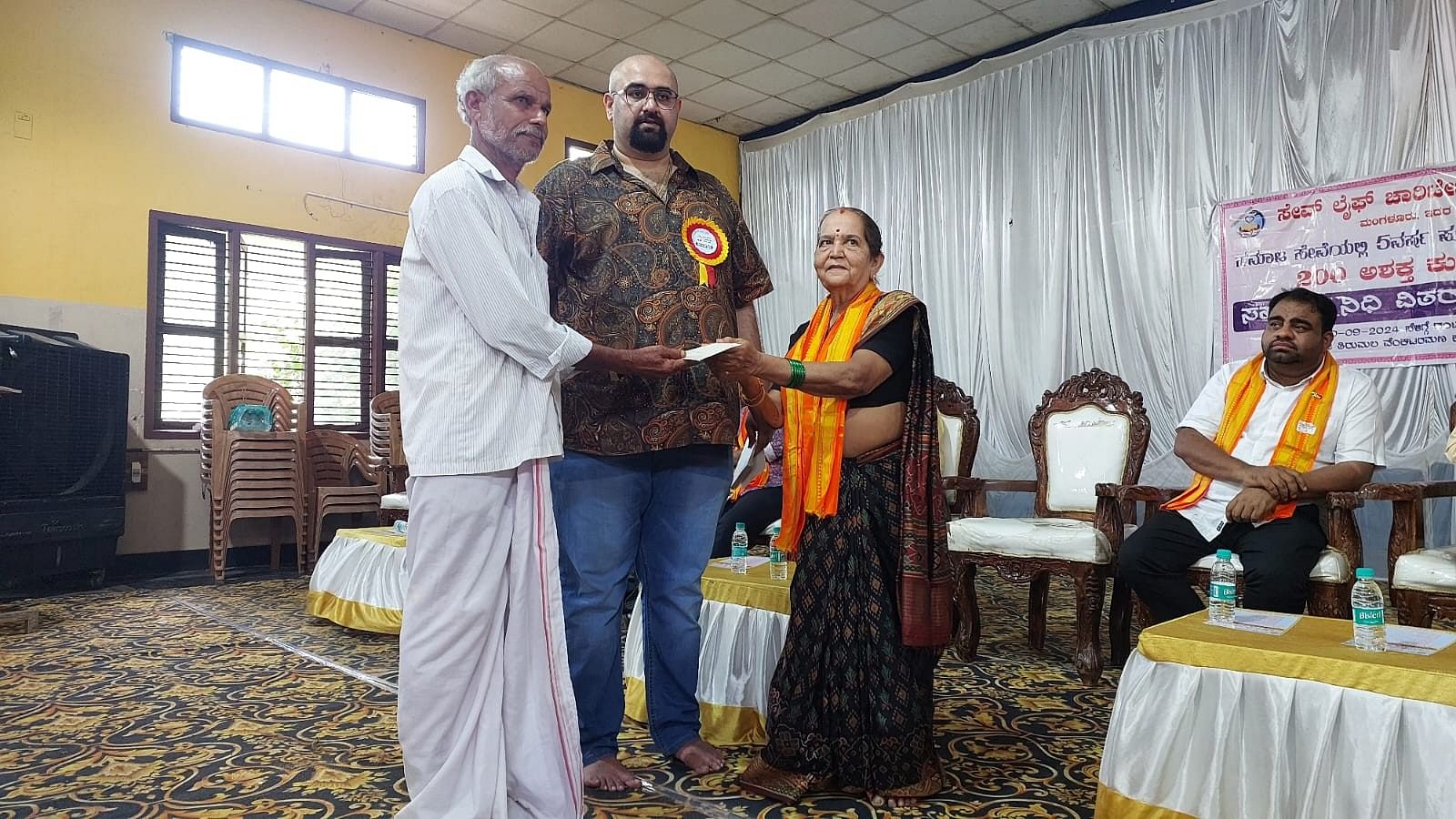 <div class="paragraphs"><p>Arjun Bhandarkar of Save Life Charitable Trust and Gayathri V Baliga seen disbursing financial help to needy people at Shri Thirumala Venkataramana Kalyan Mantap in Bantwal on Sunday. </p></div>