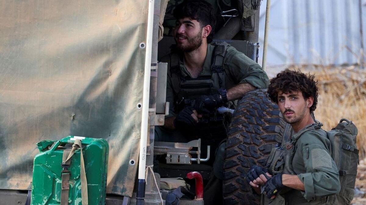 <div class="paragraphs"><p>Israeli soldiers ready their kit, amid cross-border hostilities between Hezbollah and Israel, in northern Israel.</p></div>