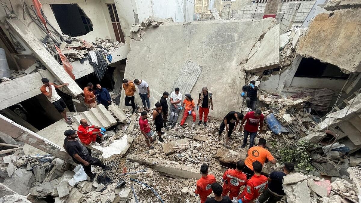 <div class="paragraphs"><p>Rescuers and people inspect the site of a strike in Ain al-Hilweh refugee camp, near the southern city of Sidon, Lebanon.</p></div>