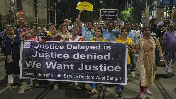 <div class="paragraphs"><p>People take part in a protest rally against the alleged sexual assault and murder of a trainee doctor at R G Kar Medical College and Hospital, in Kolkata, Tuesday, Oct 1, 2024. </p></div>