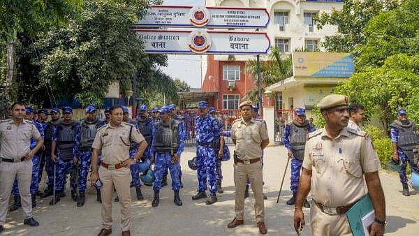 <div class="paragraphs"><p>Security personnel stand guard outside Bawana police station, where climate activist Sonam Wangchuk is being held after he was detained by Delhi Police during his 'Dilli Chalo Padyatra', in New Delhi.</p></div>