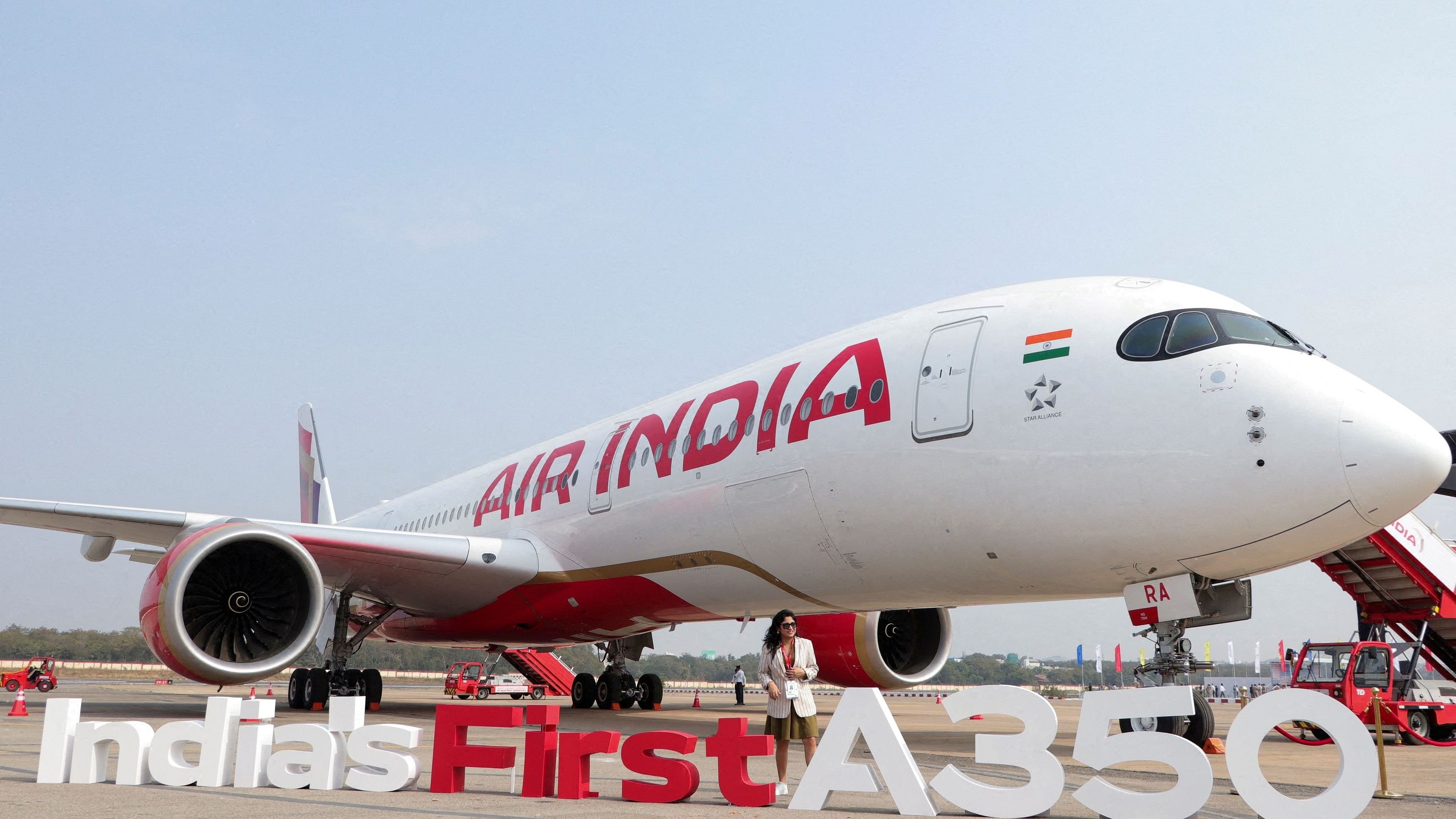 <div class="paragraphs"><p>A woman stands next to the Air India Airbus A350 aeroplane, displayed at Wings India 2024 aviation event at Begumpet airport, Hyderabad&nbsp;</p></div>