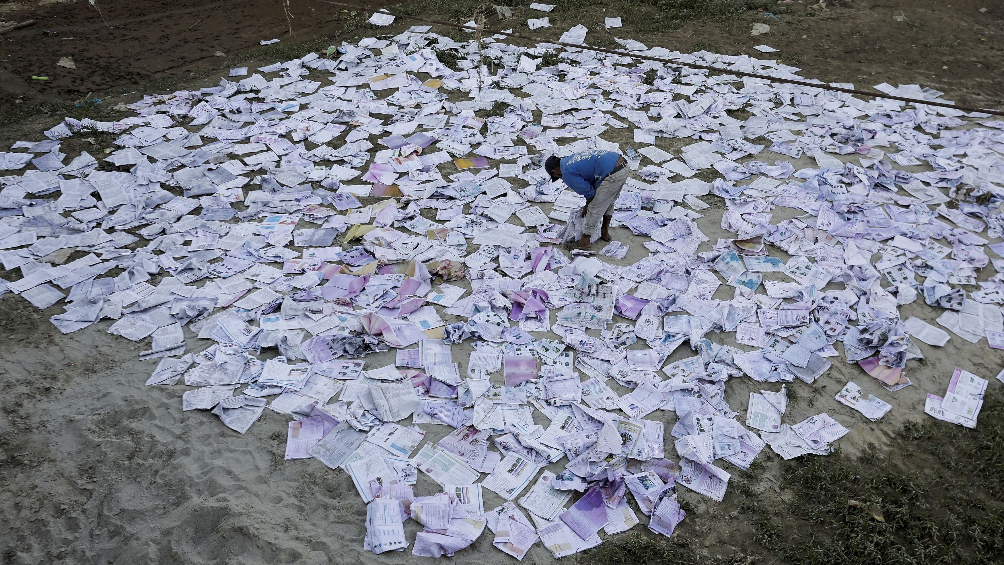 <div class="paragraphs"><p>A man dries books which soaked water during the deadly flood following heavy rainfall along the bank of Bagmati River following heavy rains, in Kathmandu, Nepal</p></div>