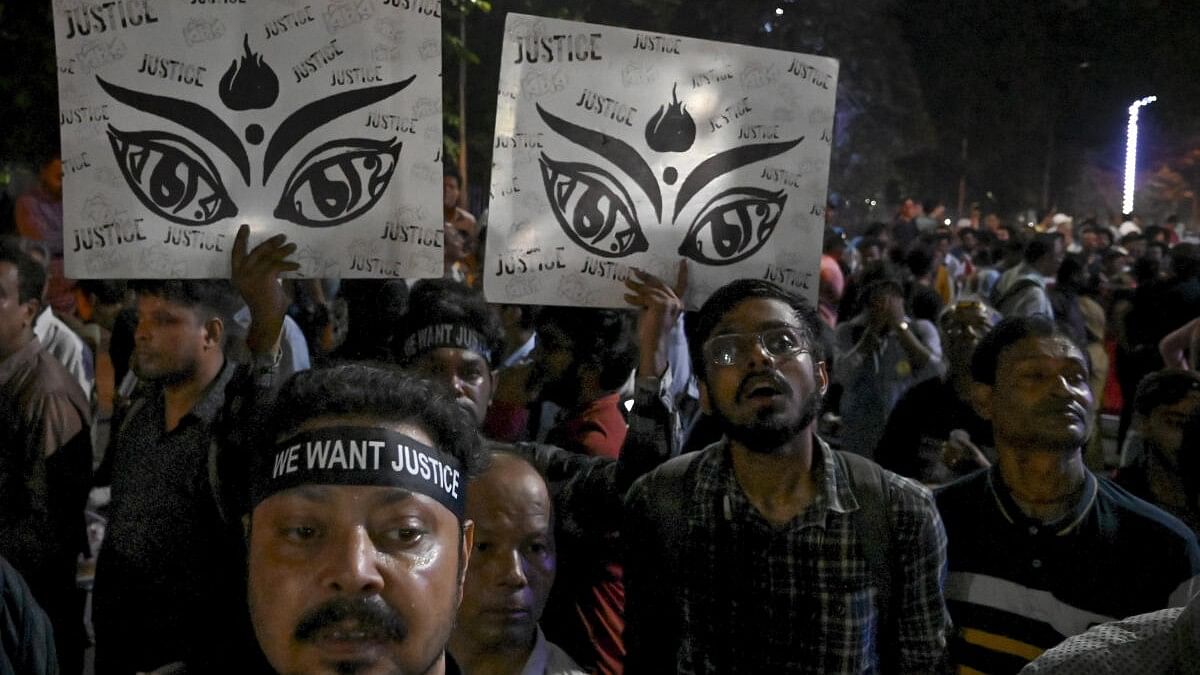 <div class="paragraphs"><p>People take part in a protest rally under the banner of Joint Platform of Doctors, against the alleged sexual assault and murder of a trainee doctor at RG Kar Medical College and Hospital, in Kolkata, Tuesday, Oct 1, 2024.</p></div>