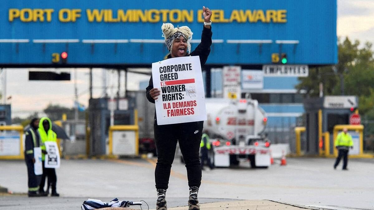 <div class="paragraphs"><p>A dockworker demonstrates after a shipping port strike went into effect across the East Coast at the Port of Wilmington, Delaware</p></div>