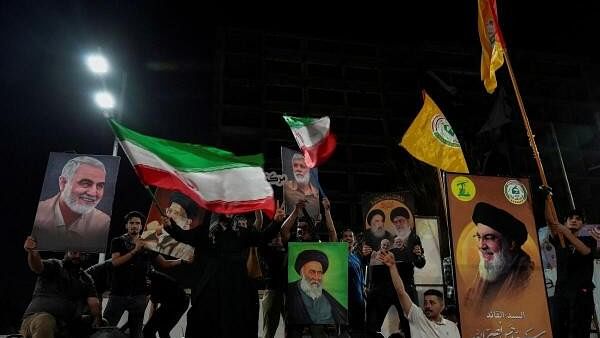 <div class="paragraphs"><p>Iraqi people celebrate on a street, after the IRGC attack on Israel, in Basra</p></div>