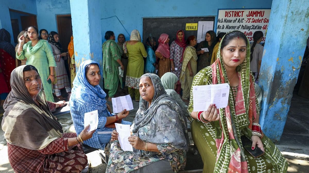 <div class="paragraphs"><p>Voters pose for photos at a polling station at Suchetgarh area before casting their votes during the third and final phase of the Jammu and Kashmir Assembly elections, in Jammu district, Tuesday, Oct. 1, 2024. </p></div>