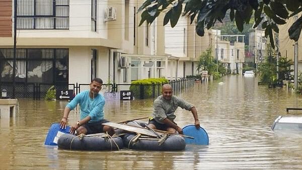 <div class="paragraphs"><p>People travel using a boat at a flood-affected area following heavy rainfall, in Kathmandu, Nepal. The floods triggered the landslides in the neighbouring country.</p></div>