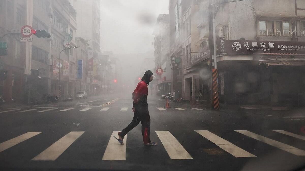 <div class="paragraphs"><p>A person crosses the road as Typhoon Krathon approaches, in Kaohsiung, Taiwan October 3, 2024.</p></div>