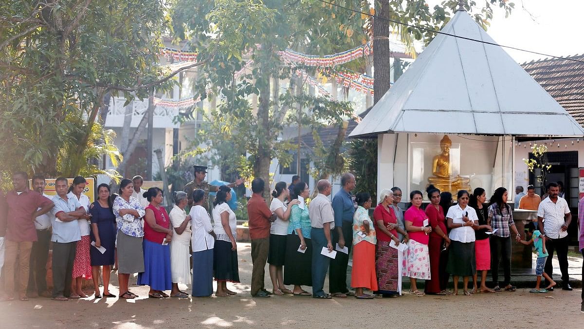 <div class="paragraphs"><p>People stand in a line to cast their vote during the presidential election in Colombo, Sri Lanka.</p></div>