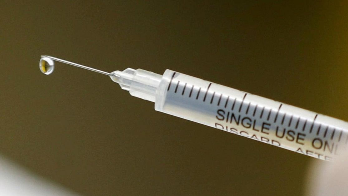 A syringe with a vaccine is seen ahead of trials by volunteers testing for the coronavirus disease. Credit: Reuters