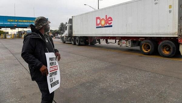 <div class="paragraphs"><p>A dockworker demonstrates after a shipping port strike went into effect across the East Coast at the Port of Wilmington, Delaware.</p></div>