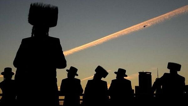 <div class="paragraphs"><p>Ultra-Orthodox Jewish people perform the Tashlich ritual of symbolically casting away their sins during Rosh Hashanah, ahead of Yom Kippur the Jewish Day of Atonement, by the East River in New York City, US.</p></div>