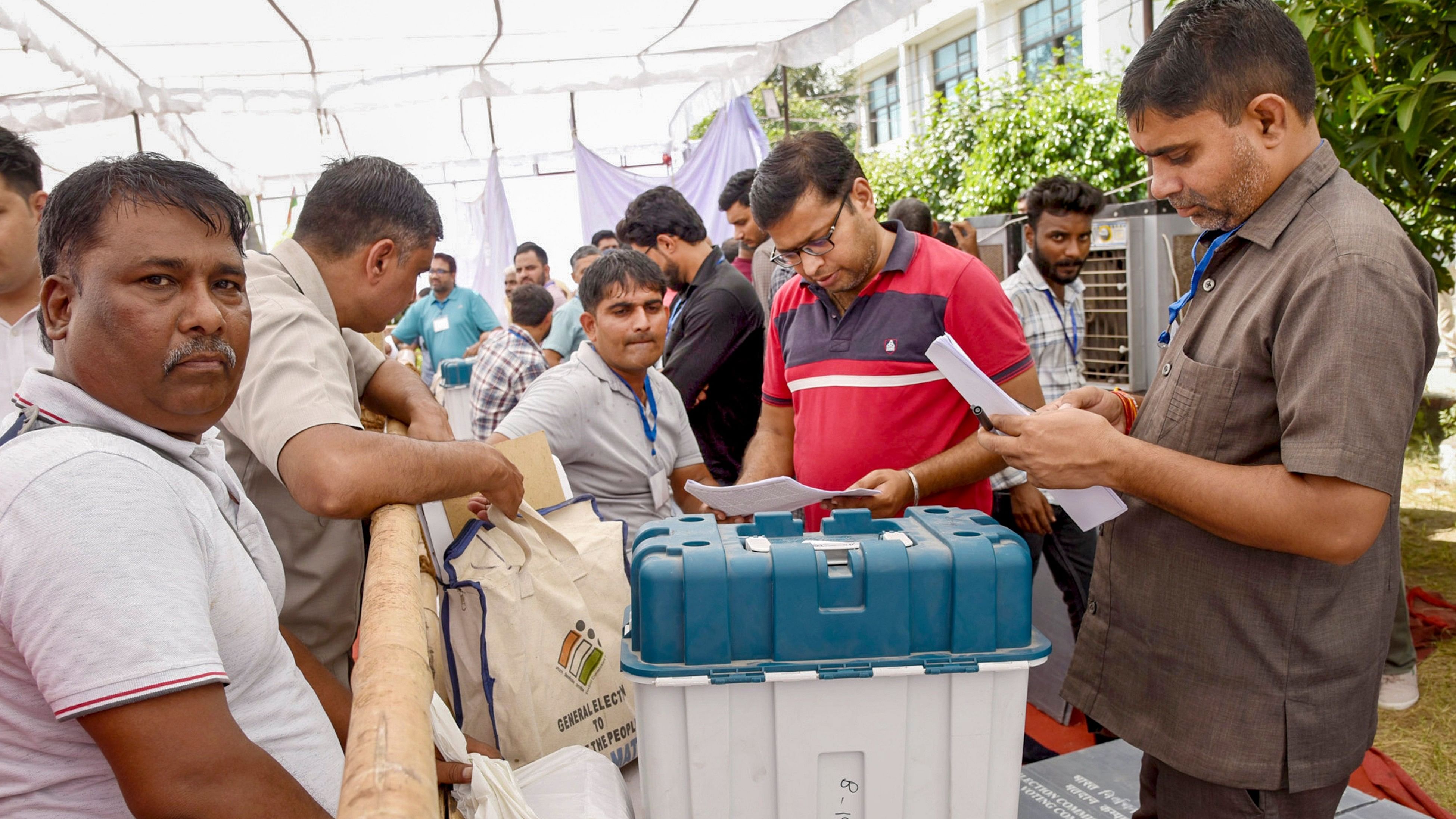 <div class="paragraphs"><p>Polling officials check EVMs and other election related material before leaving for their respective polling booths on the eve of Haryana Assembly elections, at Bits College (Mohana) in Sonipat, Oct. 4, 2024. </p></div>