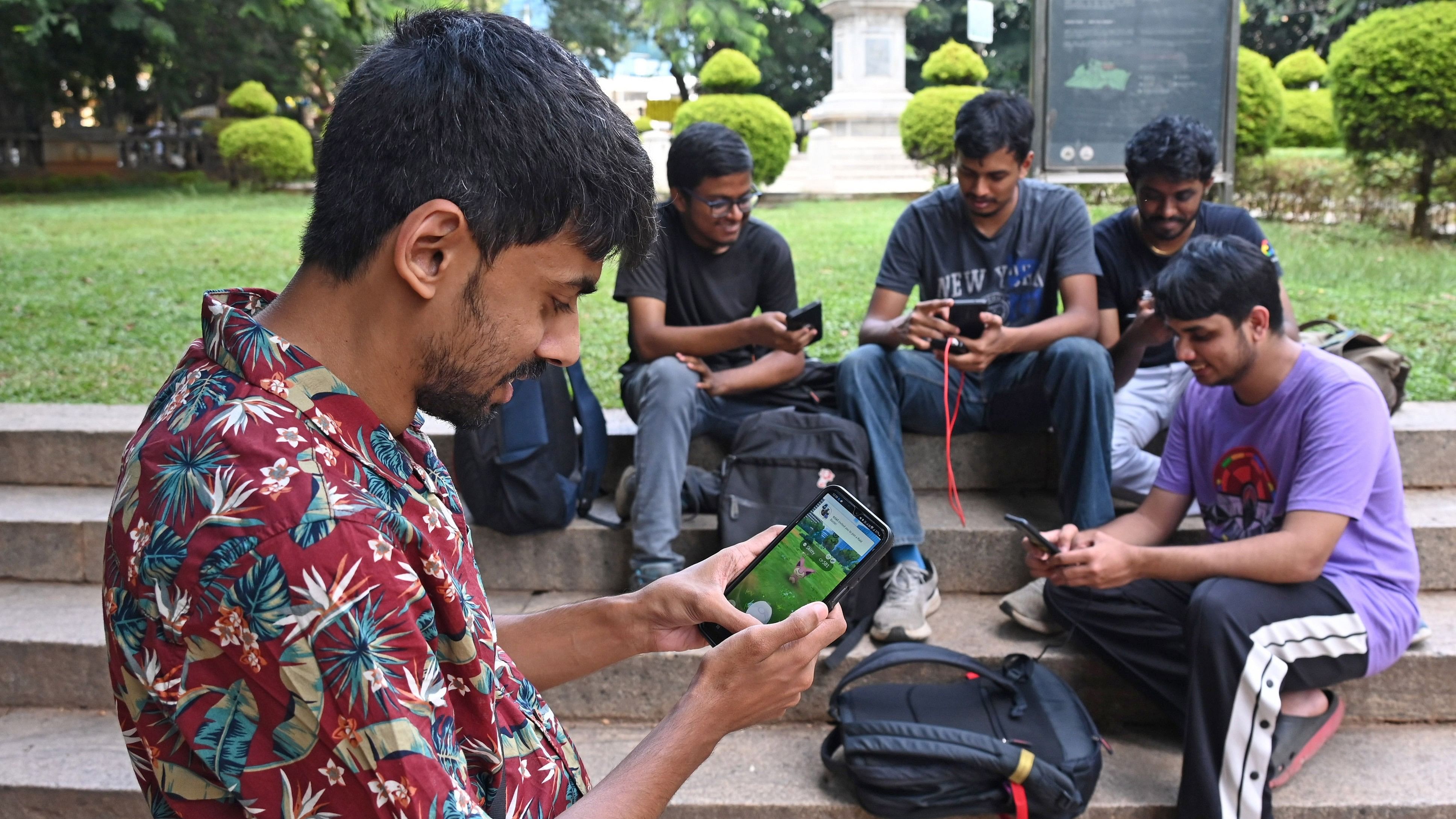 <div class="paragraphs"><p>Chaitanya Bhat (in purple) plays Pokémon Go with friends from the gaming community at Cubbon Park in Bengaluru. </p></div>