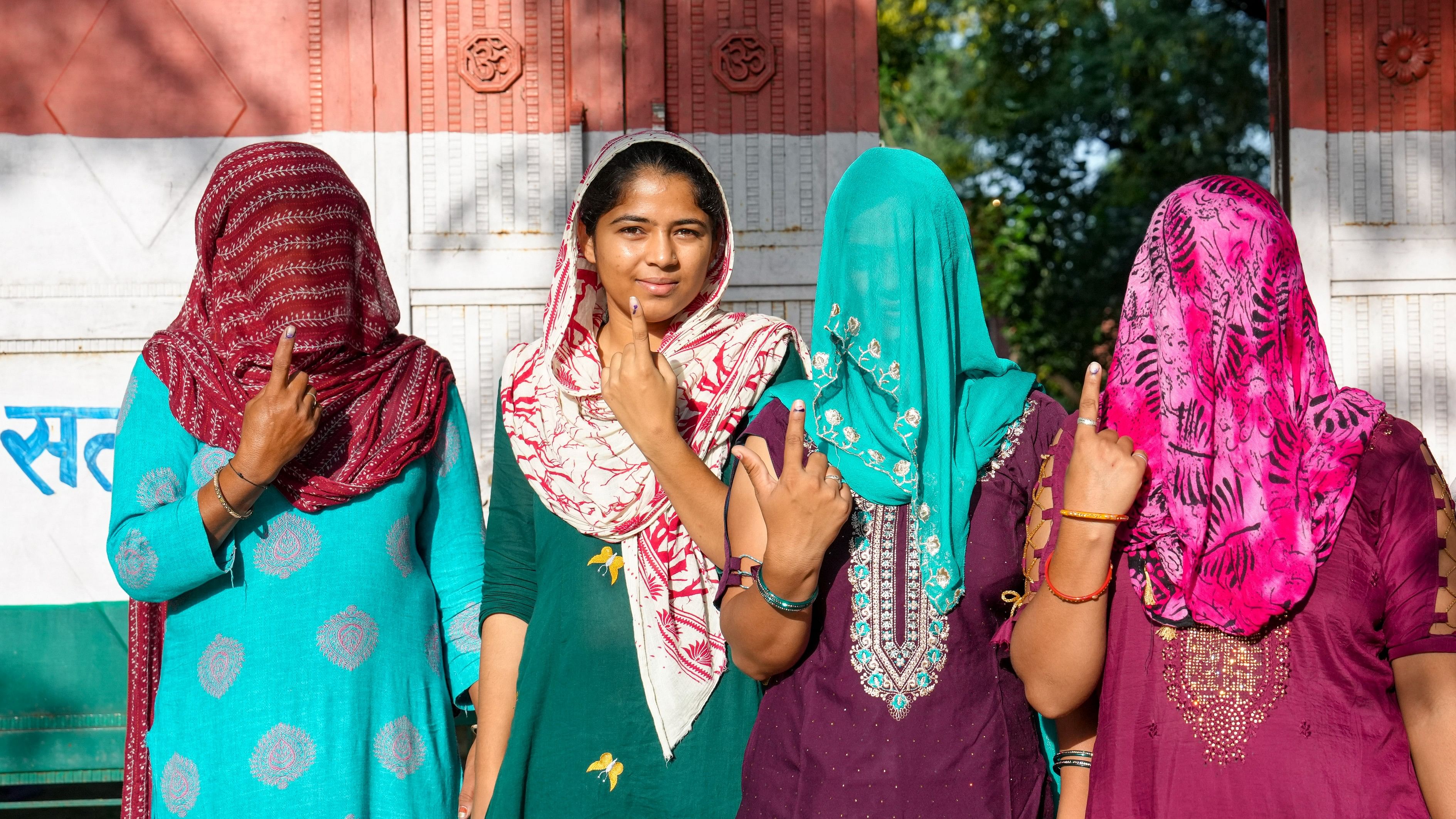 <div class="paragraphs"><p>Women show their fingers marked with indelible ink after casting their votes at a polling station at Balali village during the Haryana Assembly elections, in Charkhi Dadri district, Saturday, Oct. 5, 2024.</p></div>