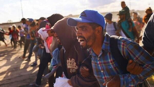 <div class="paragraphs"><p>Migrants, seeking to reach the United States, walk hand in hand during an operation carried out by agents of the National Institute of Migration (INM) of Mexico on the banks of the Rio Bravo River, the border between the US and Mexico, in Ciudad Juarez, Mexico.</p></div>