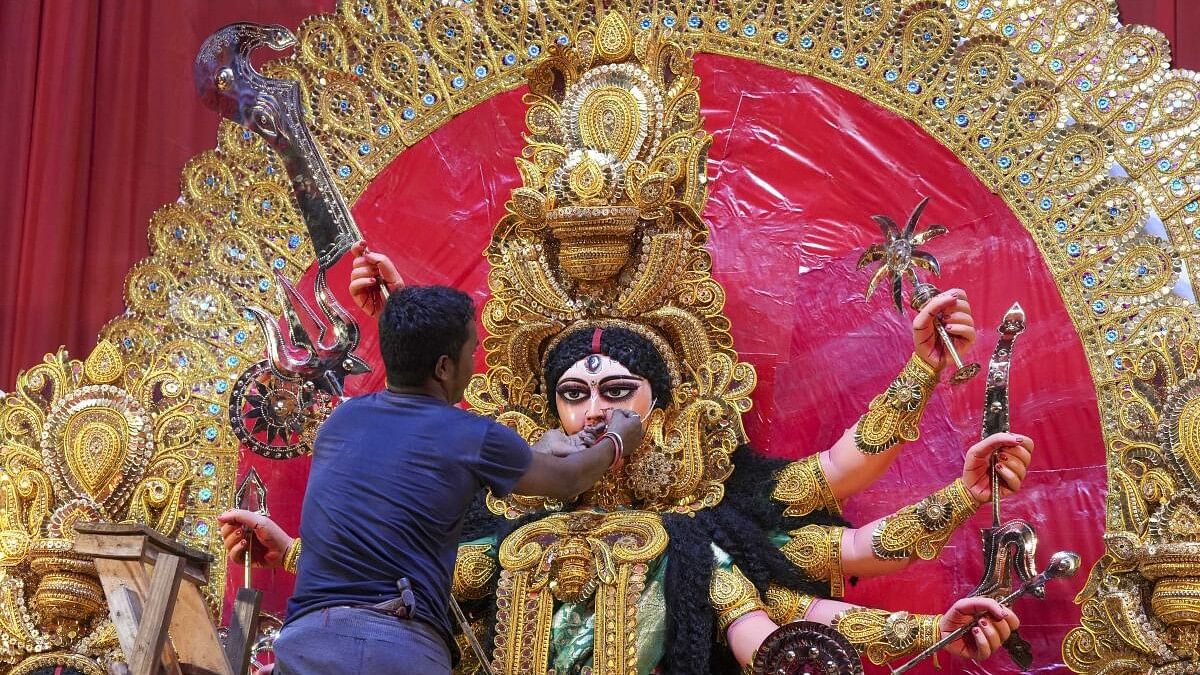 <div class="paragraphs"><p>Representative image showing a devotee decorating an idol of Goddess Durga.</p></div>