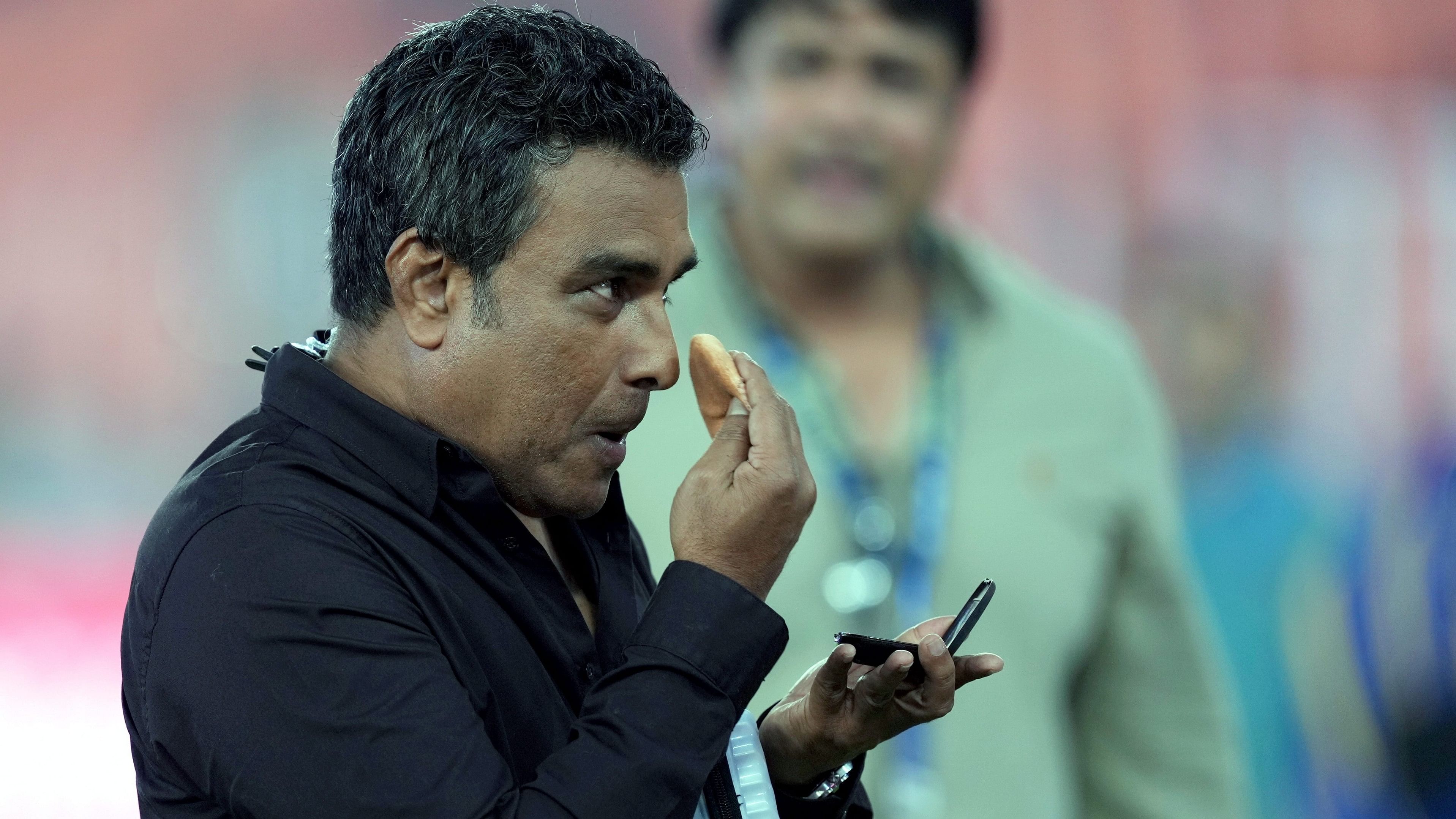 <div class="paragraphs"><p> Indian commentator and former cricketer Sanjay Manjrekar prepares before a live interview </p></div>