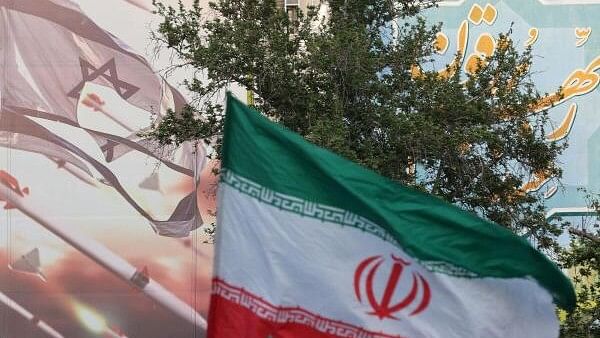 <div class="paragraphs"><p> An anti-Israel billboard is seen next to the Iranian flag during a celebration following the IRGC attack on Israel, in Tehran.</p></div>