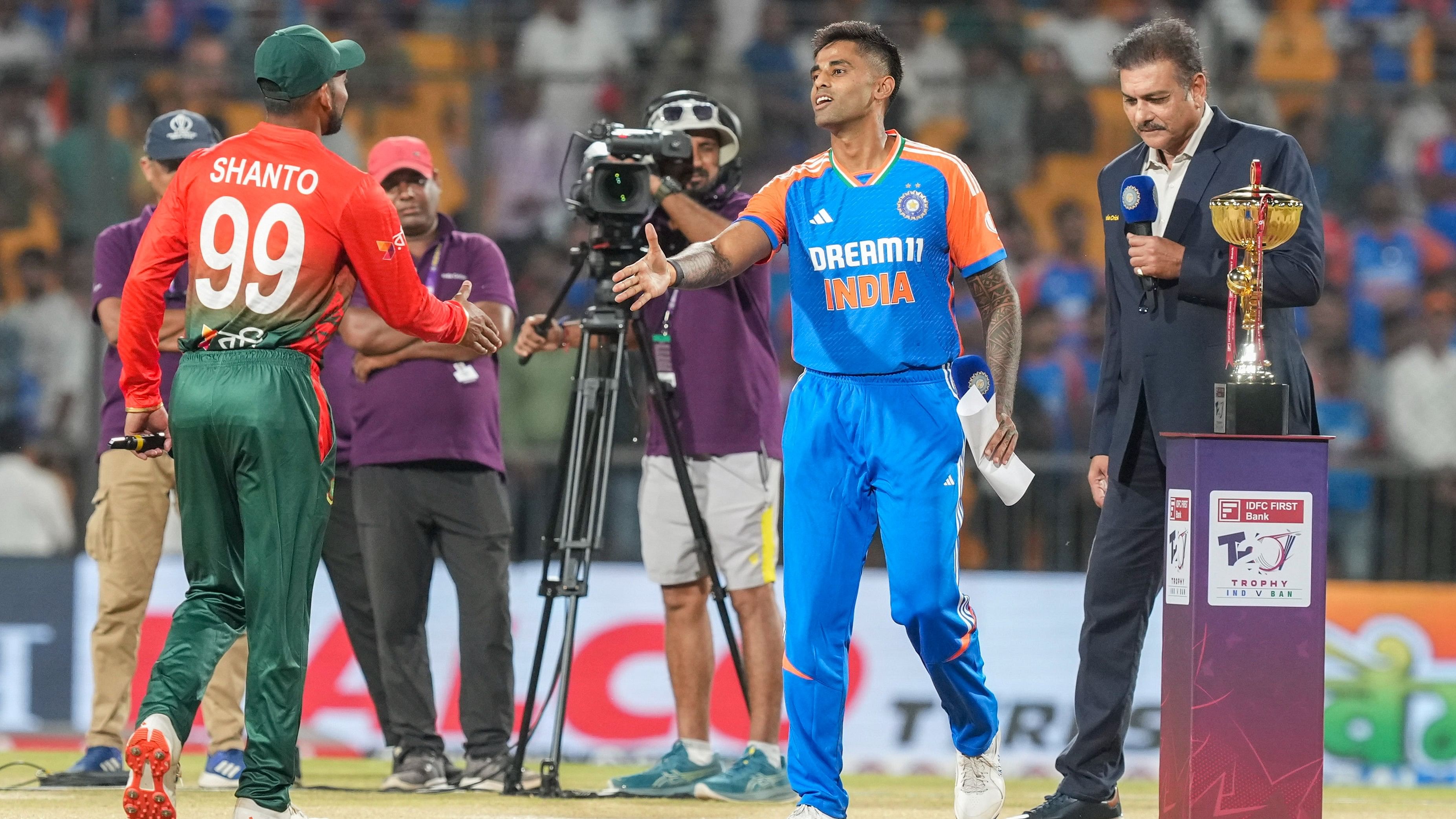 <div class="paragraphs"><p>Suryakumar Yadav and Bangladesh’s captain Najmul Hossain Shanto during the toss before the first T20 International cricket match</p></div>