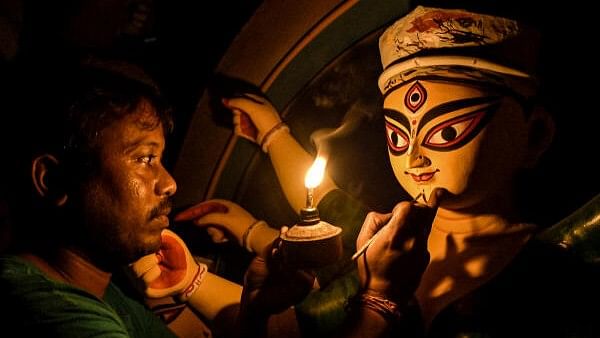 <div class="paragraphs"><p>An artisan gives final touches to an idol of Goddess Durga amid Durga Puja festivities, in Nadia district, West Bengal.</p></div>