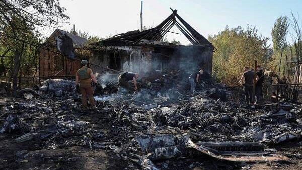 <div class="paragraphs"><p>Ukrainian service members inspect parts of a Russian aerial vehicle, which local authorities assume to be a newest heavy unmanned aerial vehicle S-70 Okhotnik (Hunter) or variation of Sukhoi fighting jet, is seen in residential area of the town of Kostintynivka after it was shot down, amid Russia's attack on Ukraine.</p></div>