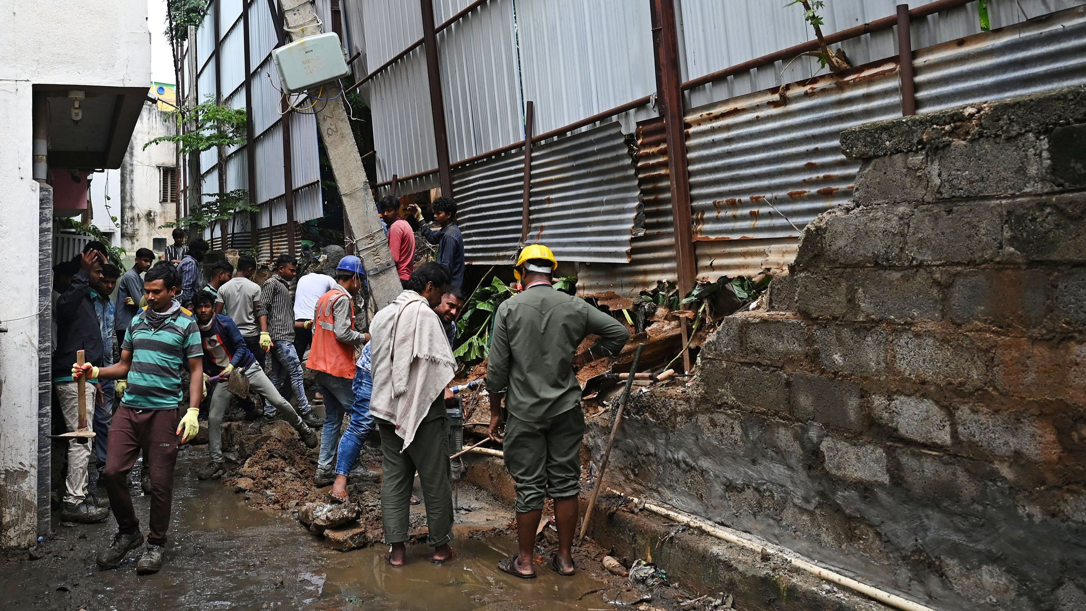 <div class="paragraphs"><p>A portion of a compound wall&nbsp;near ETA Mall, Binnypet, collapsed due to the heavy rain and overflowing drains. </p></div>