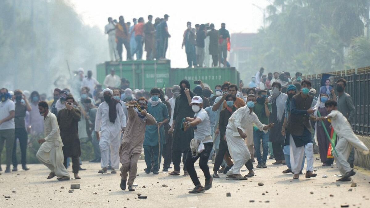 <div class="paragraphs"><p>Supporters of Imran Khan's party, throw stones during an anti-government rally in Islamabad.</p></div>