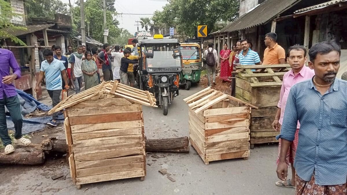 <div class="paragraphs"><p>Irate villagers block a road as they stage a protest after an incident of alleged rape and murder of a young village girl in Kultali area of South 24 Parganas district.</p></div>