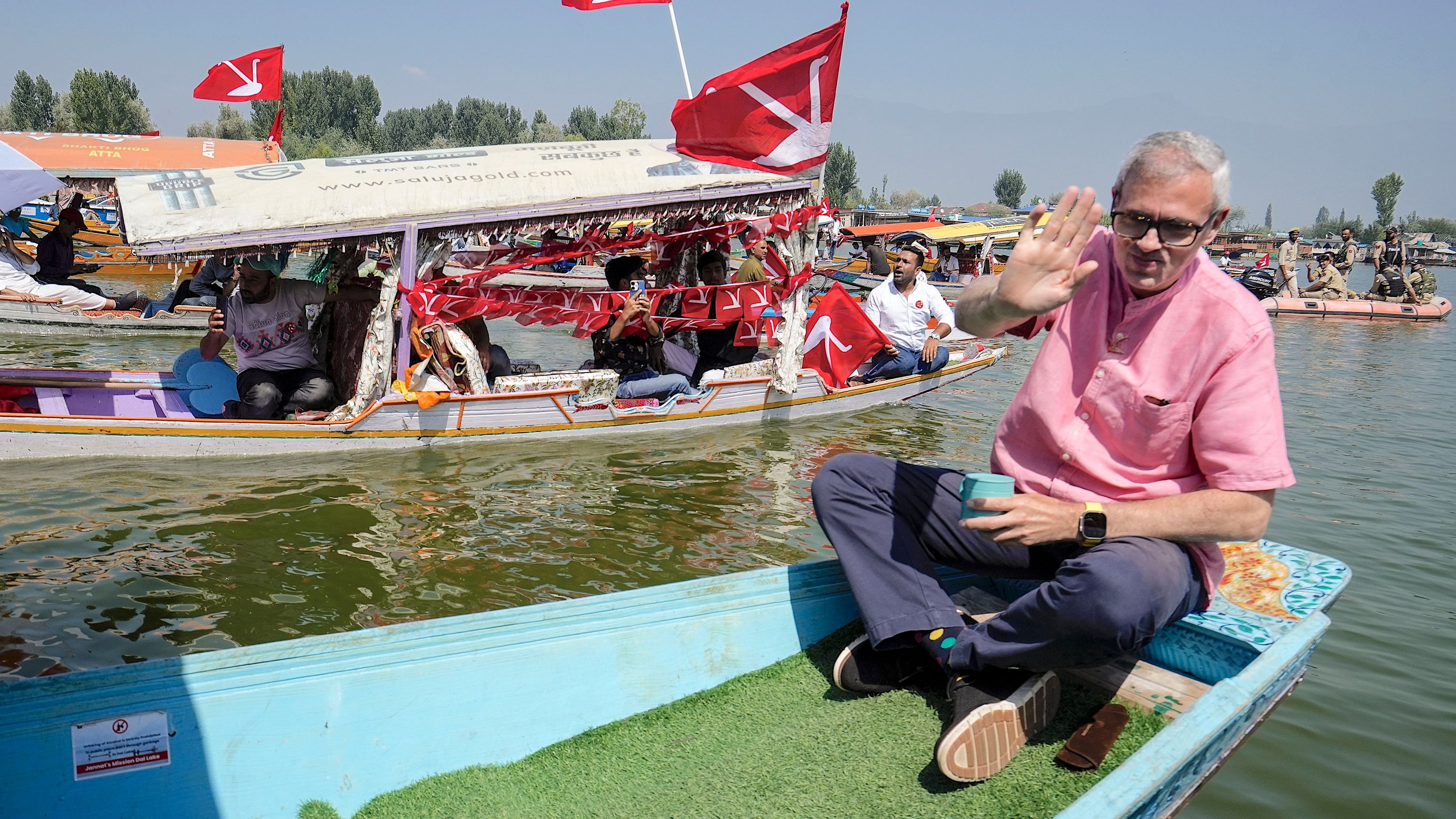 <div class="paragraphs"><p>National Conference Vice President Omar Abdullah holds the party flag as he takes a 'shikara' ride during a rally ahead of second phase election of Jammu and Kashmir Assembly, at Dal Lake in Srinagar.</p></div>