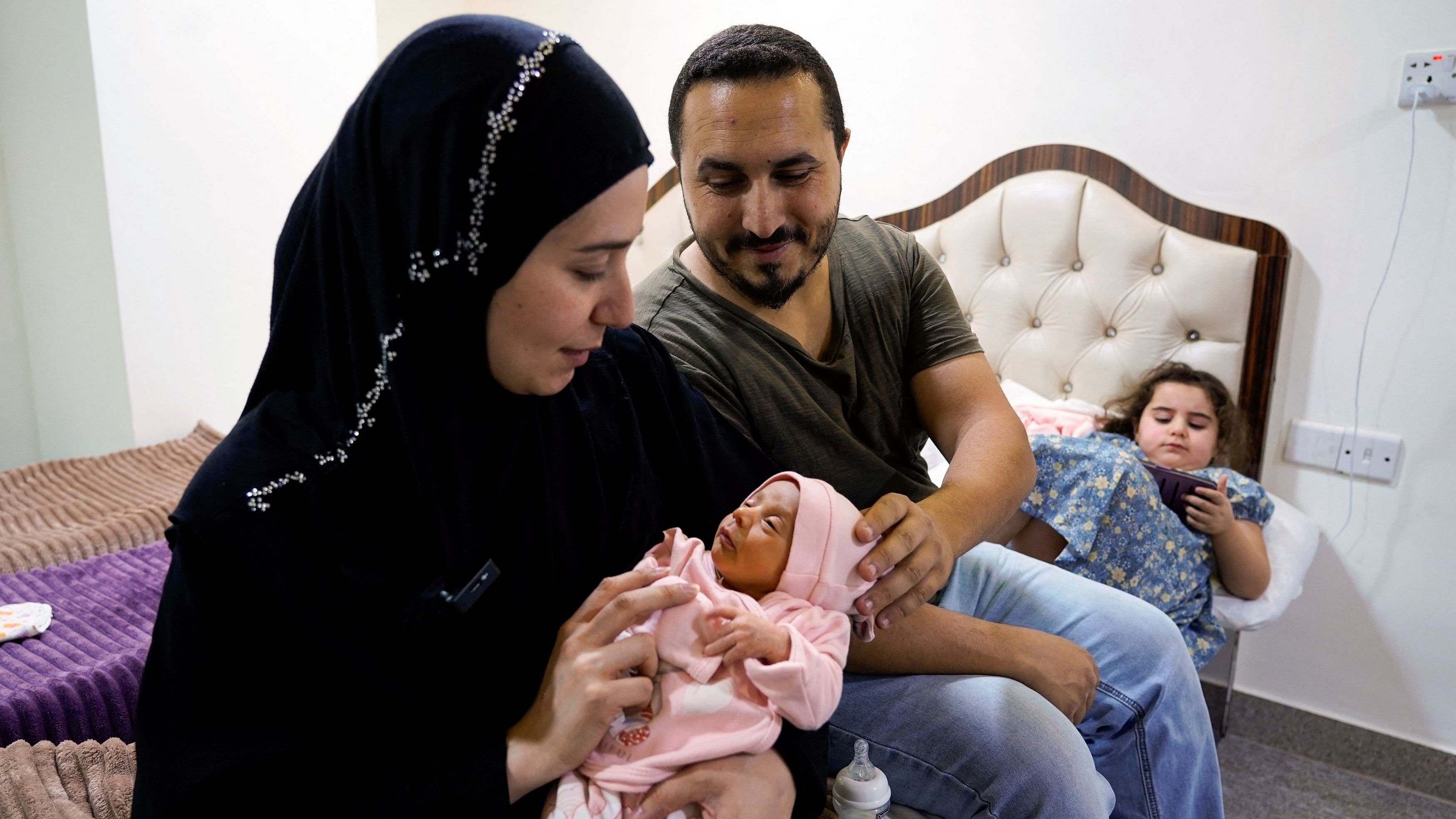 <div class="paragraphs"><p>Lubana Ismail, a displaced Lebanese woman who fled from her home in Tyre due to Israeli bombardments in Southern Lebanon, holds her newborn baby girl, Zahraa, to whom she gave birth in Iraq, as she sits with her family at a hotel in Najaf, Iraq.</p></div>