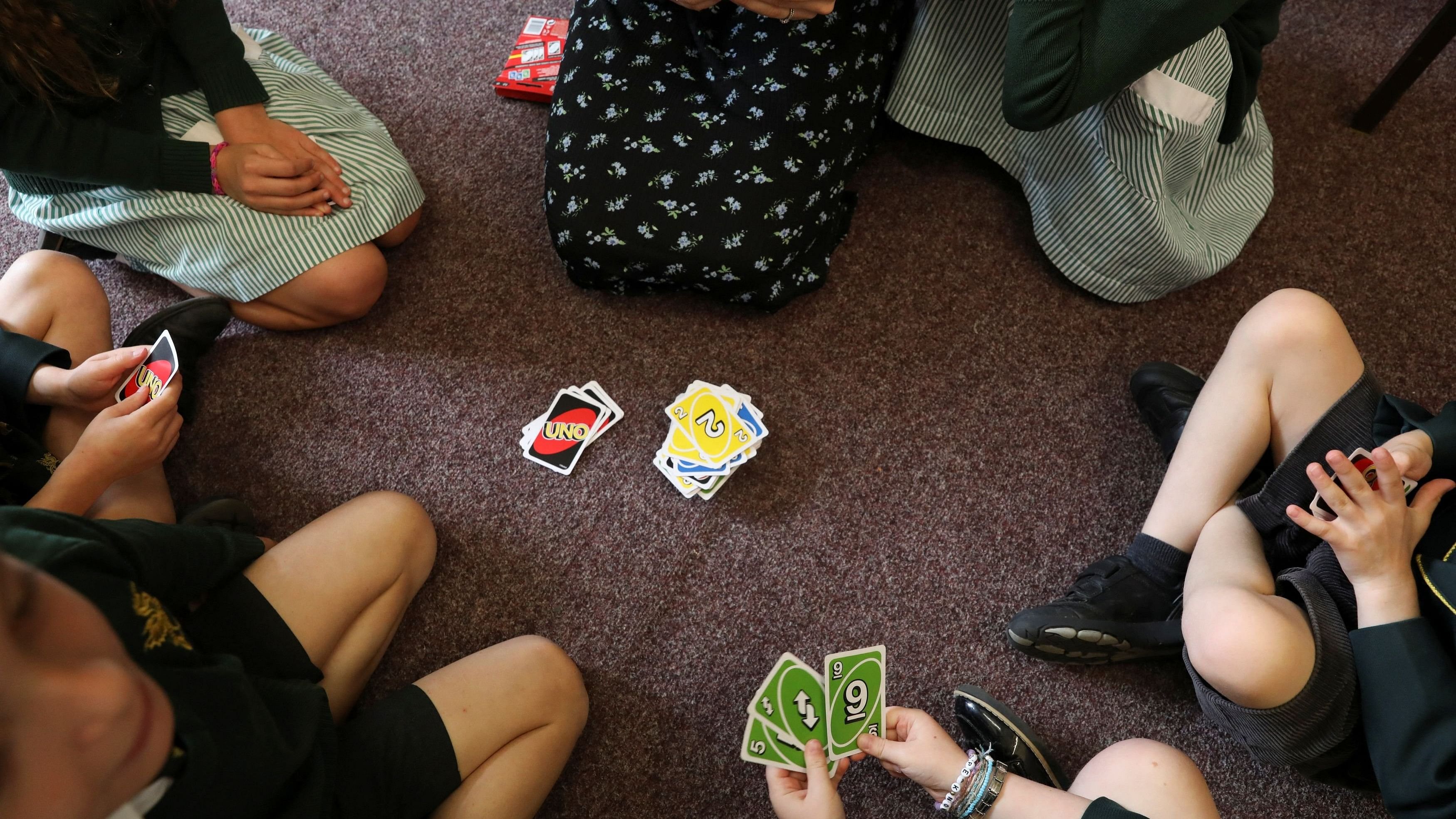 <div class="paragraphs"><p>Students play a card game 'Uno' in their classroom with teacher. Representative image.</p></div>