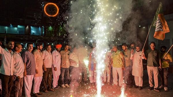 <div class="paragraphs"><p>BJP workers burst firecrackers during celebration after the party's victory in the Haryana Assembly elections, in Lucknow, Tuesday, October 8, 2024. </p></div>